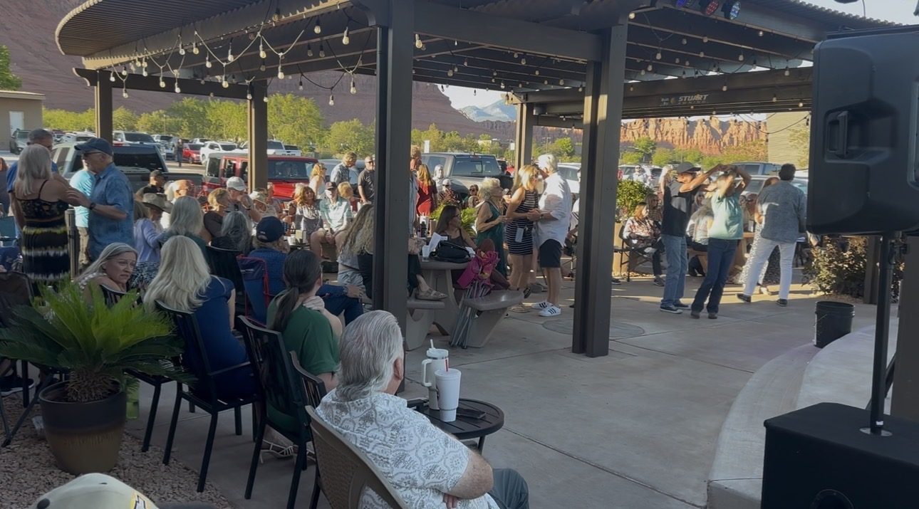 Crowd dancing and socializing at a SUMAC sunset show