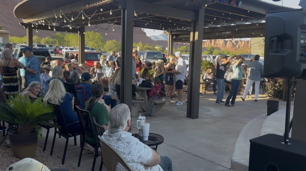 Crowd gathering before a SUMAC show with the red rocks in view