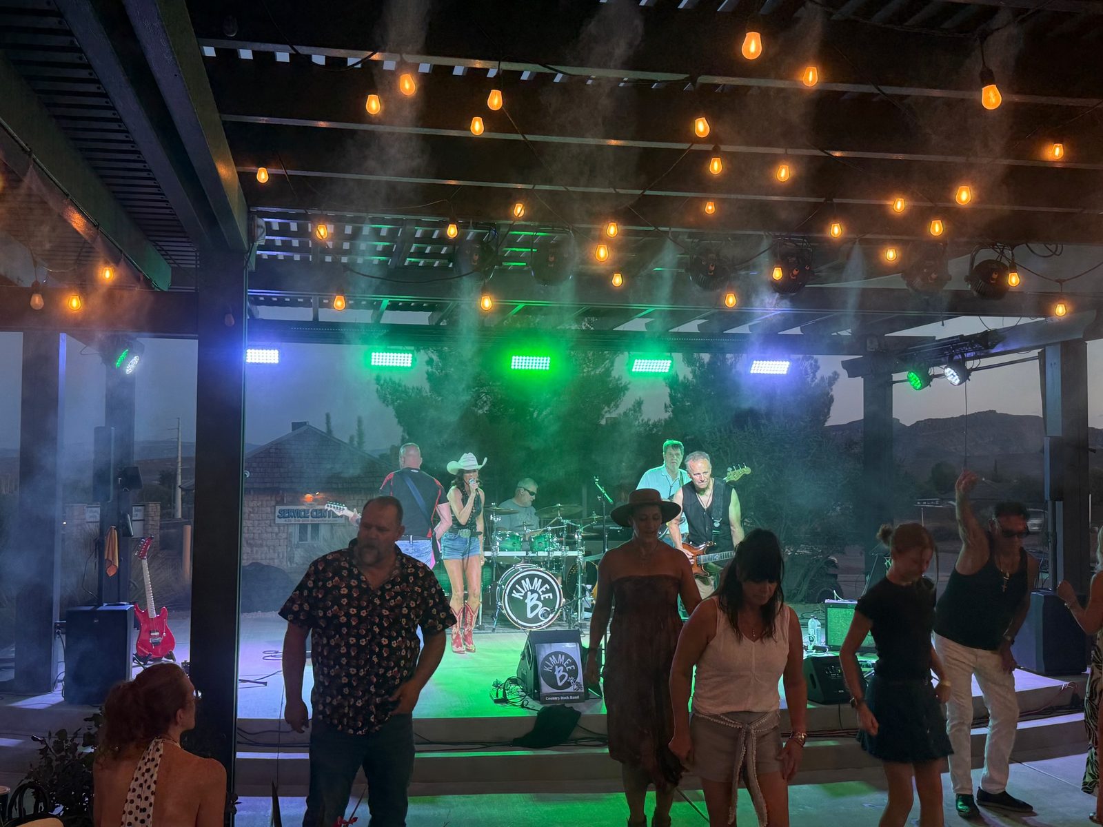 Kimmee B country rock band performing at sunset with the crowd dancing