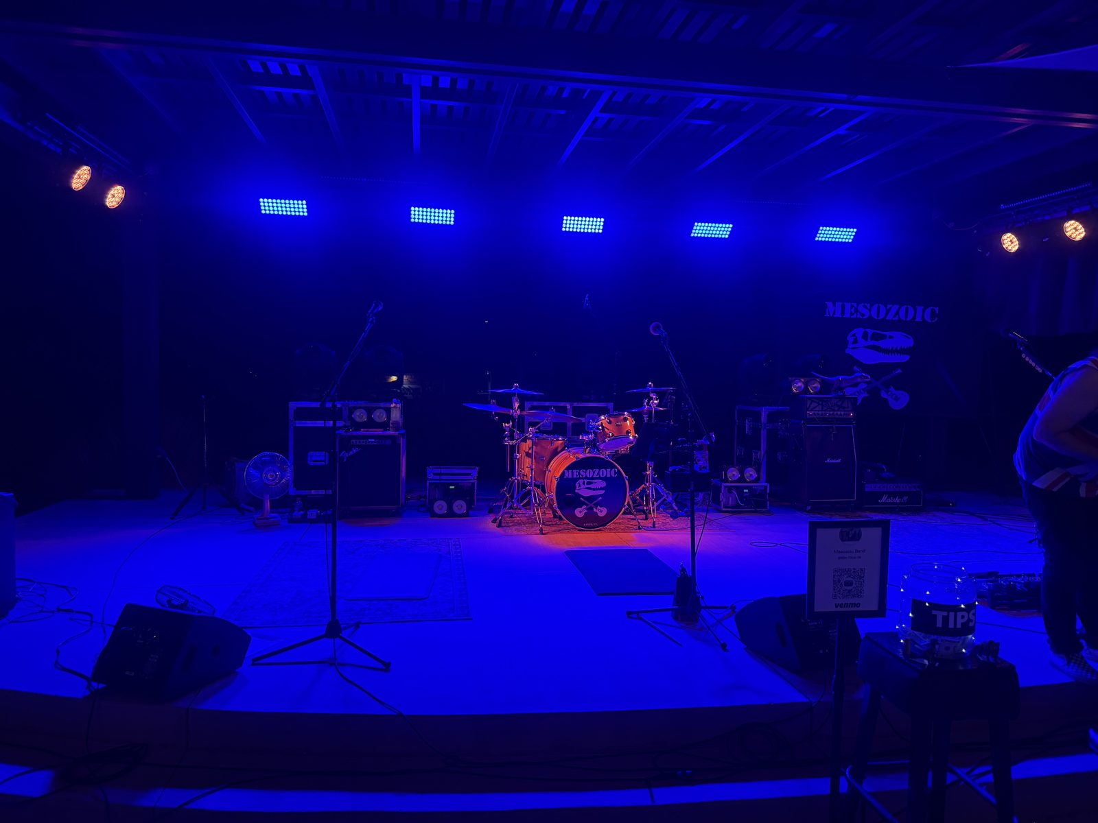 The SUMAC outdoor stage set up before a show, lit in blue